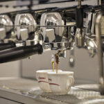 Close-up of the La Cimbali | M26 TE RE espresso machine brewing two cups of coffee.